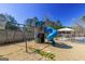A backyard playground with a blue slide and swings offers fun and recreation for children at 140 Surrey Park Dr, Fayetteville, GA 30215