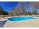 A sparkling in-ground swimming pool with diving board is surrounded by a concrete patio and fencing at 140 Surrey Park Dr, Fayetteville, GA 30215