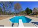 An in-ground pool with a diving board offers a luxurious and refreshing outdoor experience at 140 Surrey Park Dr, Fayetteville, GA 30215
