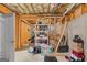 Unfinished basement with exposed wood ceiling, concrete floor, and storage shelving awaiting customization at 1202 Persimmon Way, Mcdonough, GA 30252