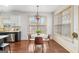 Cozy dining area with hardwood floors, a modern light fixture, and a view of the outdoors at 1202 Persimmon Way, Mcdonough, GA 30252