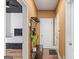 Hallway leading to main bedroom with a black tufted headboard; home organizational rack and storage at 1202 Persimmon Way, Mcdonough, GA 30252