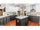 Bright kitchen featuring stainless steel appliances, white cabinets, and a center island at 1202 Persimmon Way, Mcdonough, GA 30252