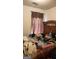 Comfortable bedroom with wooden accents, a window providing natural light, and ample space for relaxation at 775 Windemere Oak Nw Way, Lilburn, GA 30047