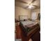 Relaxing bedroom with neutral walls, a ceiling fan, and a large window, creating a cozy atmosphere at 775 Windemere Oak Nw Way, Lilburn, GA 30047