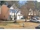 Traditional two-story home with a well-manicured lawn, showcasing charming curb appeal and an attached two-car garage at 775 Windemere Oak Nw Way, Lilburn, GA 30047