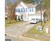 Charming two-story home featuring blue shutters, a well-maintained lawn, and an attached two-car garage at 775 Windemere Oak Nw Way, Lilburn, GA 30047