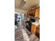 Functional kitchen featuring wood cabinets, black appliances, and durable laminate flooring at 775 Windemere Oak Nw Way, Lilburn, GA 30047