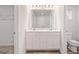 Contemporary bathroom features a double vanity, large mirror, modern lighting, and a walk-in shower with glass door at 8516 (Lot 130) Polston Place Dr, Douglasville, GA 30134