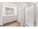 Modern bathroom features a double vanity, large mirror, modern lighting, and a walk-in shower with glass door at 8516 (Lot 130) Polston Place Dr, Douglasville, GA 30134