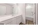 Bathroom featuring a white vanity with sink and faucet with a view of the shower and tub at 8516 (Lot 130) Polston Place Dr, Douglasville, GA 30134