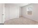 Cozy bedroom features neutral carpeting and a window for natural light, plus double closet at 8516 (Lot 130) Polston Place Dr, Douglasville, GA 30134