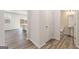 Hallway with wood-look floors, access to backyard, and a convenient half bathroom at 8516 (Lot 130) Polston Place Dr, Douglasville, GA 30134