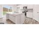 Modern kitchen featuring stainless appliances, gray granite counters, and wood-look floors at 8516 (Lot 130) Polston Place Dr, Douglasville, GA 30134