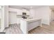 Modern kitchen showcases white cabinets, granite countertops, stainless steel appliances and a functional kitchen island at 8516 (Lot 130) Polston Place Dr, Douglasville, GA 30134