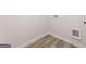 A well-lit laundry room featuring light wood-look floors and washer/dryer hookups at 8516 (Lot 130) Polston Place Dr, Douglasville, GA 30134
