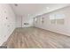 Spacious living room with wood-look flooring, a modern fireplace, and multiple windows at 8516 (Lot 130) Polston Place Dr, Douglasville, GA 30134
