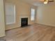 Bright living room with a fireplace, light hardwood floors, and natural light at 80 Rosemoore Dr, Covington, GA 30014