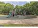 Playground featuring multiple slides and play equipment surrounded by lush green trees on a sunny day at 80 Rosemoore Dr, Covington, GA 30014