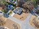 Stunning aerial view of a home with a well-manicured lawn, inviting pool, and peaceful surroundings at 100 Lanyard Bnd, Peachtree City, GA 30269
