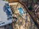 Overhead view of the backyard, featuring a sparkling pool, wooden deck, and neatly fenced property line at 100 Lanyard Bnd, Peachtree City, GA 30269