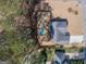 Aerial view of a home with pool, fenced backyard and mature trees in a well-maintained neighborhood at 100 Lanyard Bnd, Peachtree City, GA 30269