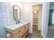 Bathroom featuring a rustic vanity with stone countertop and access to walk-in closet at 100 Lanyard Bnd, Peachtree City, GA 30269
