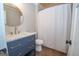Bathroom featuring a blue vanity with gold hardware and a shower with a white shower curtain at 100 Lanyard Bnd, Peachtree City, GA 30269