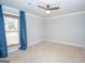 Bedroom featuring neutral walls, carpeted floors and a large window with blue curtains at 100 Lanyard Bnd, Peachtree City, GA 30269