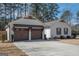 Charming single-story home with two-car garage on spacious lot, beautiful tree line in the background at 100 Lanyard Bnd, Peachtree City, GA 30269