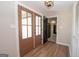 Bright foyer with hardwood floors and stylish double doors leading to other rooms, open entryways at 100 Lanyard Bnd, Peachtree City, GA 30269