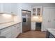 Bright kitchen featuring stainless steel appliances, granite counters, and modern white cabinets at 100 Lanyard Bnd, Peachtree City, GA 30269