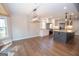 Open concept kitchen with a granite island and stainless appliances, seamlessly connecting to dining area at 100 Lanyard Bnd, Peachtree City, GA 30269