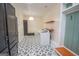 View of laundry room with cabinets, shelves, trendy flooring and modern washer and dryer at 100 Lanyard Bnd, Peachtree City, GA 30269