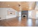 Bright and airy living room featuring a fireplace, built-in shelving and elegant wood ceiling at 100 Lanyard Bnd, Peachtree City, GA 30269