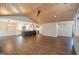 Spacious living room with an island kitchen, fireplace, and elegant wood ceiling, creating an inviting atmosphere at 100 Lanyard Bnd, Peachtree City, GA 30269