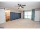 Spacious main bedroom featuring a ceiling fan, board and batten accent wall and ensuite bathroom access at 100 Lanyard Bnd, Peachtree City, GA 30269