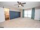 Large main bedroom featuring a ceiling fan, stylish accent wall, and ensuite bathroom at 100 Lanyard Bnd, Peachtree City, GA 30269