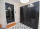 Mudroom with trendy flooring, storage cabinets and black painted front door at 100 Lanyard Bnd, Peachtree City, GA 30269