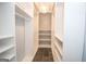 Bright walk-in closet with custom shelving and a decorative chandelier at 100 Lanyard Bnd, Peachtree City, GA 30269