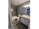 Bathroom featuring modern granite countertop, vanity, and updated tiling in shower at 2747 Vining Ridge Ter, Decatur, GA 30034