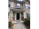 Inviting front porch with brick accents and a secure black metal entry door at 2747 Vining Ridge Ter, Decatur, GA 30034