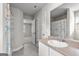 Well lit bathroom featuring a modern vanity, framed mirror, shower with colorful curtain, and an open doorway at 1756 Beckworth Ln, Hampton, GA 30228