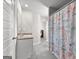 Bathroom features a single sink vanity and a colorful ocean-themed shower curtain at 1756 Beckworth Ln, Hampton, GA 30228