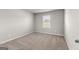 Carpeted bedroom featuring a window with blinds and light-colored walls at 1756 Beckworth Ln, Hampton, GA 30228