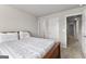 Bedroom featuring neutral walls, with a white quilted bedspread and open doorways at 1756 Beckworth Ln, Hampton, GA 30228