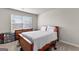 Bedroom features a large window and a wooden bed frame with decorative pillows at 1756 Beckworth Ln, Hampton, GA 30228