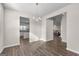 Open dining room with a chandelier, wood floors, and access to the kitchen and living room at 1756 Beckworth Ln, Hampton, GA 30228