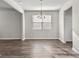 Bright dining area with contemporary lighting, hardwood floors, and a convenient doorway at 1756 Beckworth Ln, Hampton, GA 30228
