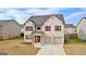 Lovely two-story home with brick details, attached garage, and a welcoming front entrance at 1756 Beckworth Ln, Hampton, GA 30228